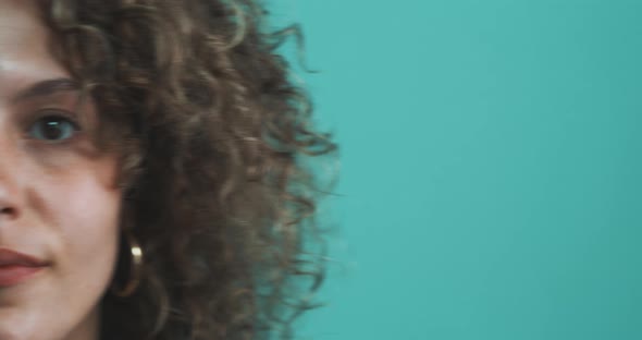 Woman stands infront of blue Backdrop alt