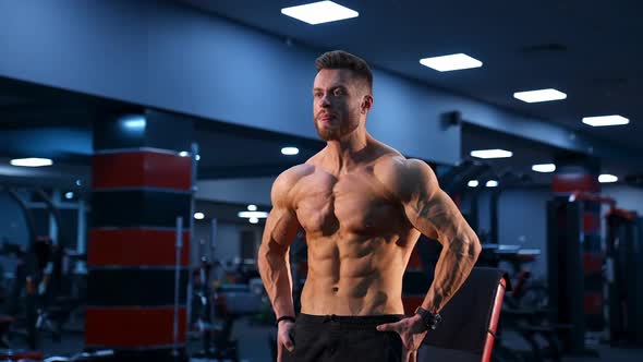 Brutal strong bodybuilder pumping up muscles. Bodybuilding and indoor sports concept. alt