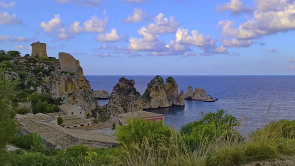 Clouds over stacks or Faraglioni of Scopello and Torre Doria tower in Sicily. Italy alt