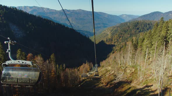 Scenic View From Cable Car Cabin Moving Down Among the Autumn Colored Trees in Magnificent Caucasus