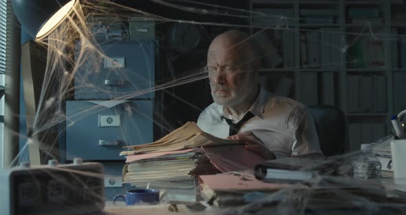 Businessman searching for files in the abandoned office