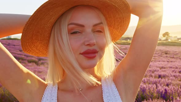 Portrait of a Blonde Woman with Hat in Lavender Fields on Summer