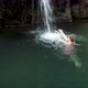 Woman Swimming Towards Secret Waterfall - VideoHive Item for Sale