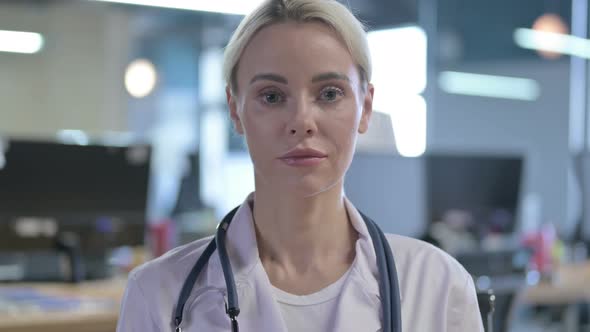 Portrait of Serious Young Professional Doctor Looking at the Camera alt