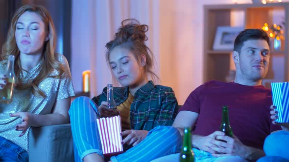 Friends with Beer and Popcorn Watching Tv at Home 57 alt