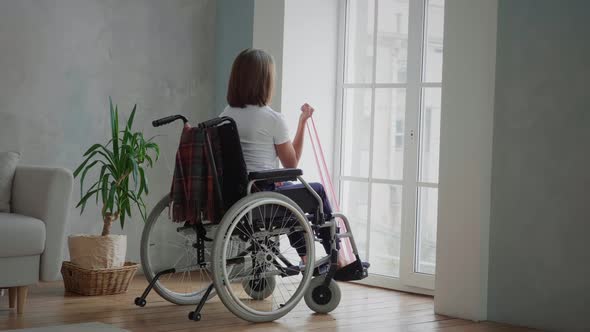 Disabled woman is exercising at home alt