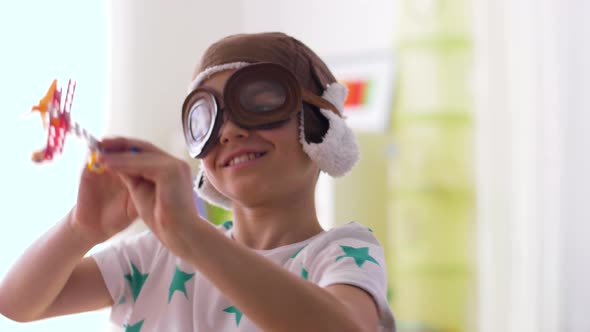 Boy in Pilot Hat Playing with Airplane Toy at Home 19 alt