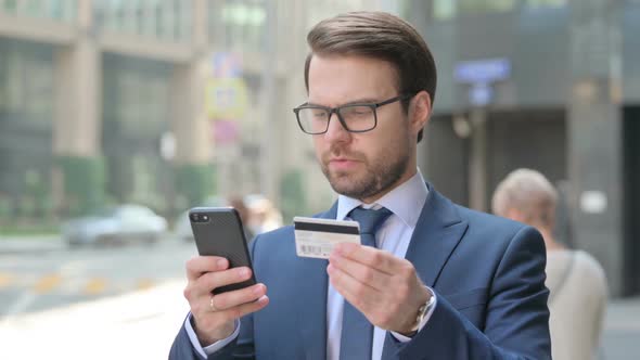 Portrait of Businessman having Online Payment Success on Smartphone alt