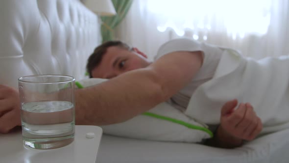 Middle-aged man taking medicine. Taking pills for headaches and fever.