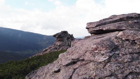 Huge Rocky Formation on the Edge of a Grassy Slope alt