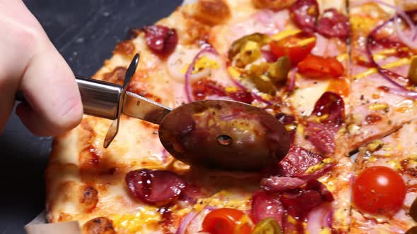 Closeup Cutting Pizza with a Round Cutter Knife Slow Motion