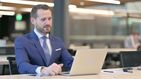 Middle Aged Businessman Talking on Video Call on Laptop alt
