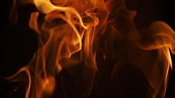 slow motion footage of wood burning in a fireplace with the fire licking the wood, background with c alt