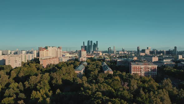 Aerial Drone Shot Zoom in of Trees and Moscow City on Background