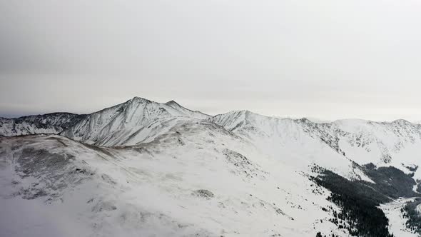  4k view above the Rocky Mountains and snow covered Arapaho and Roosevelt National Forests  alt