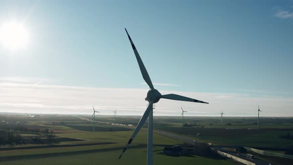 Aerial Drone View Windmills Wind Turbines Producing Clean Ecological Electricity By Road in Green alt
