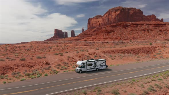 Aerial view of an RV pulled over to the side of the road in Monument Valley, Utah alt