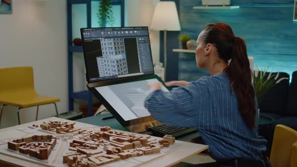 Businesswoman Working on Building Model with Touch Screen alt