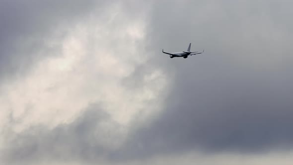 Airplane in Cloudy Gray Sky alt
