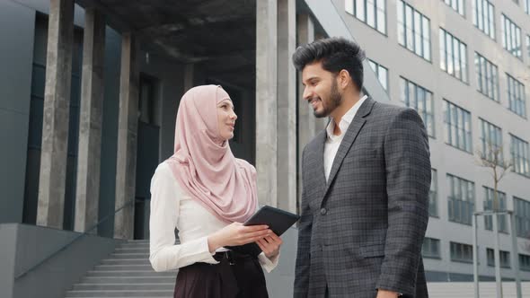 Smiling Arabian Business Colleagues Standing on City Street and Taking Selfie on alt