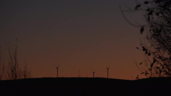 Wind power generator turbines, at a sunny evening dusk, in Hoga Kusten, Vasternorrland, Sweden alt