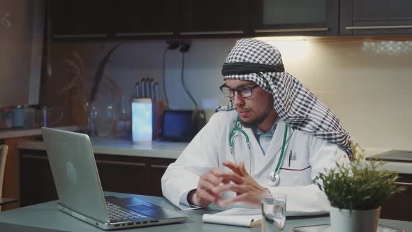 Arab Doctor Conducting Medical Consultation Online on Computer From Home