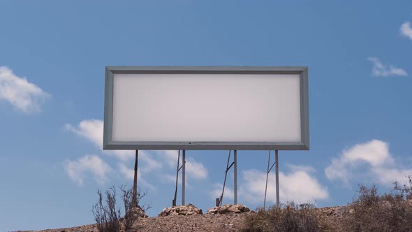 Billboard Against a Blue Sky with White Clouds Timelapse alt
