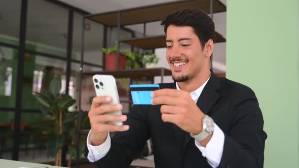 Cheerful Latin Man Makes Purchase Online