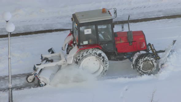 Tractor removing snow from walkways