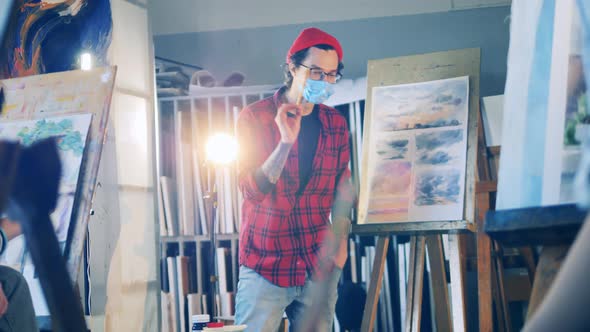 Art Teacher is Explaining Painting During the Group Class alt