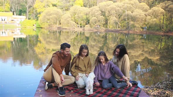 Beautiful Family at Autumn Warm Day Near Lake