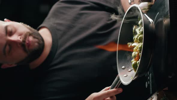 Vertical Video of Chef Frying Green Brussels Sprouts Cabbage in Pan Closeup alt