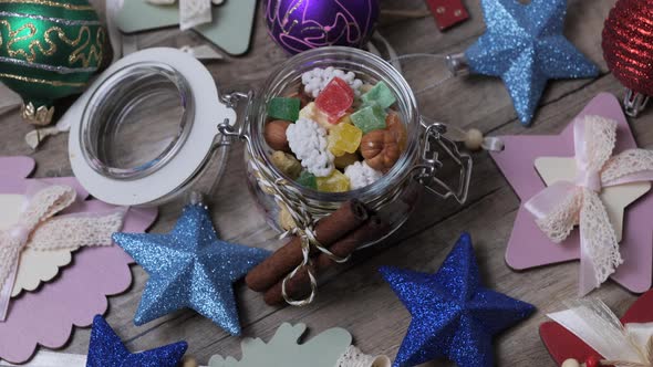 Christmas decorations with sweets on wooden table rotating.