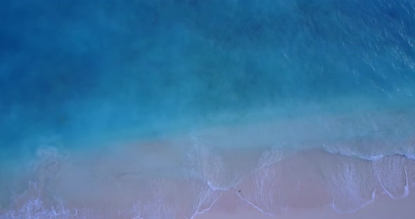 Daytime overhead abstract view of a white sand paradise beach and blue water background in high reso alt