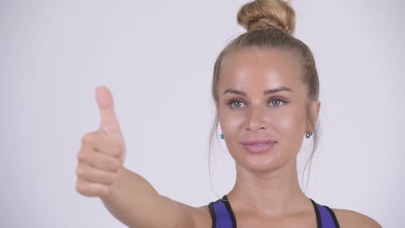Face of Happy Young Blonde Woman Giving Thumbs Up alt