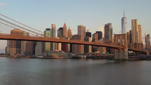 An aerial view over the East River on a beautiful morning. The camera pan left and truck right facin alt
