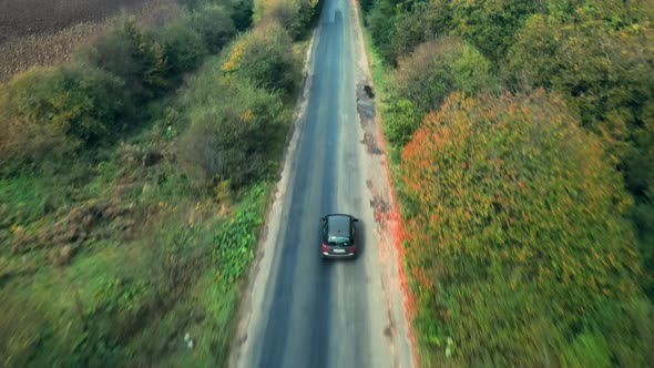 Aerial View Of White Car Driving On Country Road