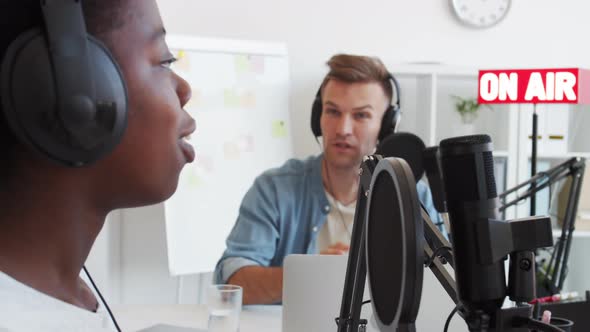 Two Diverse People Communicating in Broadcast Studio alt