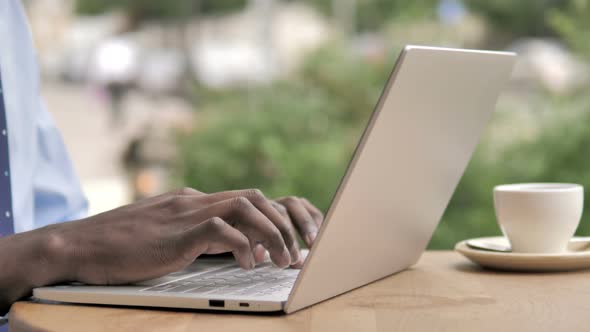 African Hands Typing on Laptop alt