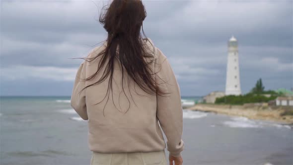 Woman Walk To the Lighthouse and Make Heart
