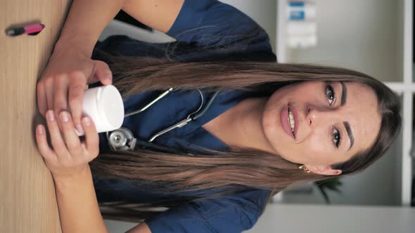 Vertical Video Young Female Doctor in the Process of Consulting Drugs alt