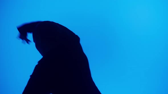 Closeup of Talented Woman Dancing Hip Hop on Blue Neon Background in Studio alt