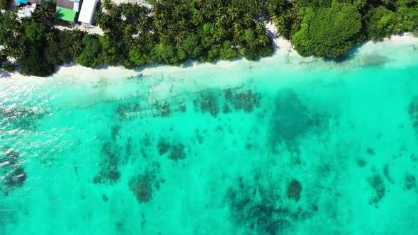 Wide above clean view of a white paradise beach and blue water background