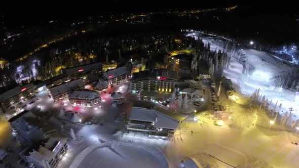 Flying over winter resort at night, Finland alt