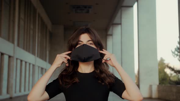 Woman is wearing face protective mask alt