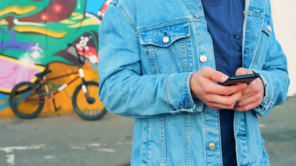 Casual Teenager Typing Text Massage with a Smartphone, Close Up. alt