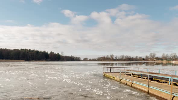 Beginning of Spring. Jetty on the Lake in the Ice