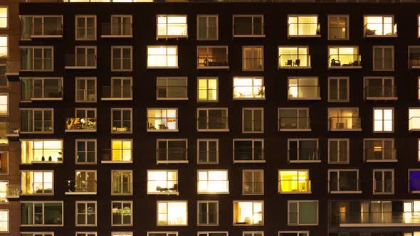 The exterior of a modern apartment block at night