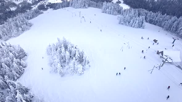 Aerial View of the Mountain Peak People Skiing and Snowboarding alt