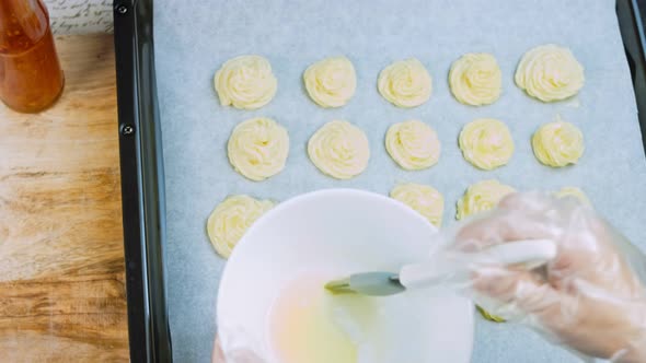 The Chef Greases the Potato Cookies with Oil with a Brush alt